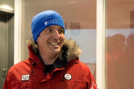 Wearing a parka and UOIT toque,  CBC Television personality Rick Mercer braces for the indoor blizzard awaiting him inside ACE's climatic wind tunnel.